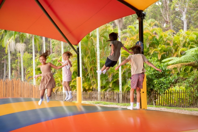 Children jumping on the giant jumping pillow
